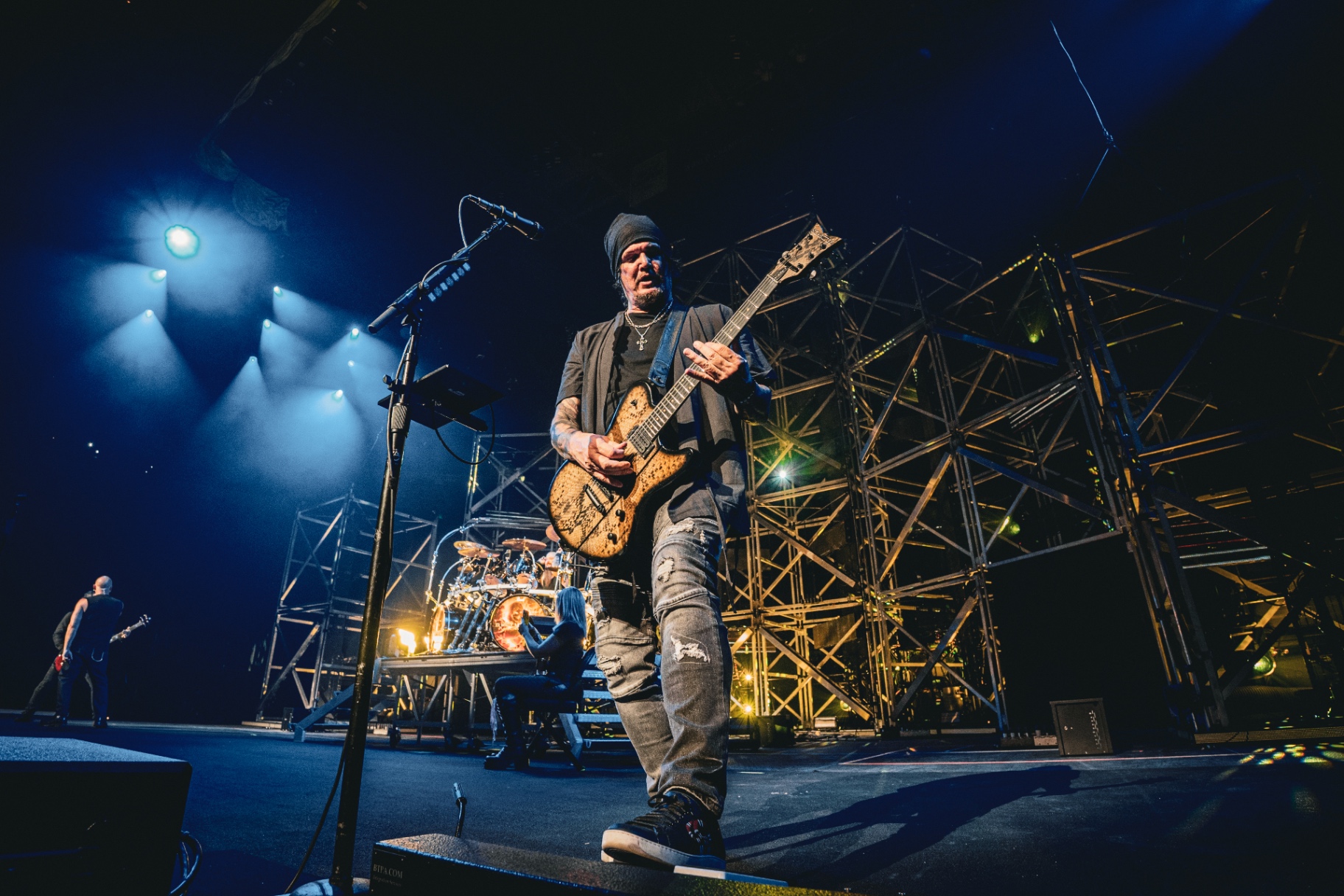 Guitarist under blue stage lights